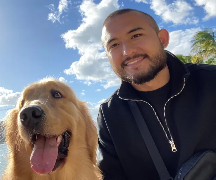 Franco Celeste outdoors with his dog